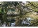 Waterfront home featuring a dock, lovely landscaping, and picturesque water reflections at 7417 Seagull Way, Tampa, FL 33635