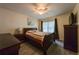 Bedroom with queen-sized bed, bedside tables, wood flooring, and a ceiling fan at 7828 Hardwick # 923, New Port Richey, FL 34655