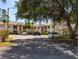 Well-maintained exterior of this two-story townhome with ample parking and mature trees at 7828 Hardwick # 923, New Port Richey, FL 34655