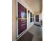 Inviting front entry with glass and screen door, exterior light fixture and covered porch at 7828 Hardwick # 923, New Port Richey, FL 34655