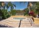 Relax in this community hot tub surrounded by tropical landscaping at 7828 Hardwick # 923, New Port Richey, FL 34655