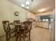 Eat-in kitchen featuring a dining table and chairs, white appliances, and tile flooring at 7828 Hardwick # 923, New Port Richey, FL 34655