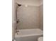 Close-up of a clean white tub and tiled shower, showcasing modern fixtures at 7828 Hardwick # 923, New Port Richey, FL 34655