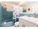 Bathroom with vintage blue tile, bathtub and bright white vanity, blending retro charm with modern elements at 9024 140Th Way, Seminole, FL 33776