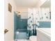 Bathroom with vintage blue tile, bathtub and bright white vanity, with shower and modern elements at 9024 140Th Way, Seminole, FL 33776