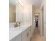 Bright bathroom with white vanity, tile flooring, and large mirror, creating a fresh and inviting atmosphere at 9024 140Th Way, Seminole, FL 33776