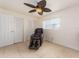 Bedroom featuring a massage chair, a ceiling fan, two closets and two windows, for functional relaxation at 9024 140Th Way, Seminole, FL 33776