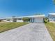 Charming single story home featuring a well-manicured lawn and a concrete driveway leading to the garage at 9024 140Th Way, Seminole, FL 33776