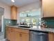 Charming kitchen with granite countertops, stainless steel dishwasher, and a view to the living room at 9024 140Th Way, Seminole, FL 33776