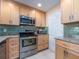 Cozy kitchen features stainless steel appliances and granite countertops, creating an inviting space at 9024 140Th Way, Seminole, FL 33776