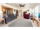 Open living room features tile floors, large windows, comfortable furniture, and open view of the kitchen at 9024 140Th Way, Seminole, FL 33776