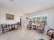 Open-concept living room showcasing classic furnishings, neutral tones, and tile flooring at 9024 140Th Way, Seminole, FL 33776