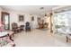 Spacious living room featuring classic furnishings, tile flooring, and views into the dining area at 9024 140Th Way, Seminole, FL 33776