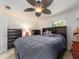 Spacious main bedroom features a ceiling fan, large bed, and and dressers at 9024 140Th Way, Seminole, FL 33776