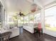 Inviting sunroom with large windows, ceiling fan, and comfortable seating offers a relaxing space at 9024 140Th Way, Seminole, FL 33776