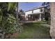Picturesque backyard with mature trees, lush lawn, brick paver patio, and a view of the pool at 11102 Avery Oaks Dr, Tampa, FL 33625