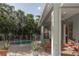 Backyard featuring a brick paver patio with seating, a pool, and lush tropical landscaping at 11102 Avery Oaks Dr, Tampa, FL 33625
