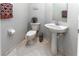 Powder room featuring a pedestal sink, toilet, and light gray paint at 11102 Avery Oaks Dr, Tampa, FL 33625