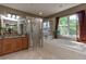 Bathroom featuring granite counters, bathtub, and walk-in shower at 11102 Avery Oaks Dr, Tampa, FL 33625