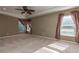 Large bedroom featuring windows, ceiling fan, and neutral carpet at 11102 Avery Oaks Dr, Tampa, FL 33625