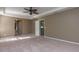 Spacious primary bedroom with ceiling fan and neutral carpet at 11102 Avery Oaks Dr, Tampa, FL 33625