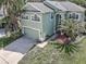 Aerial view of a charming home with a well-manicured lawn and an attached two-car garage at 11102 Avery Oaks Dr, Tampa, FL 33625