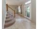 Spacious foyer with tile floors, a staircase, and a decorative front door at 11102 Avery Oaks Dr, Tampa, FL 33625