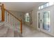 Bright foyer with tile flooring, staircase, and a front door with decorative glass at 11102 Avery Oaks Dr, Tampa, FL 33625