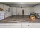 Spacious garage with epoxy flooring, overhead storage, and ample room for vehicles and storage at 11102 Avery Oaks Dr, Tampa, FL 33625