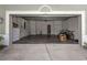 Clean, spacious garage with epoxy flooring, overhead storage, and plenty of room for vehicles at 11102 Avery Oaks Dr, Tampa, FL 33625
