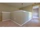 Upstairs hallway with neutral walls and carpet, leading to other rooms in the home at 11102 Avery Oaks Dr, Tampa, FL 33625