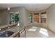 Eat-in kitchen featuring granite countertops, stainless steel appliances, and sunlit breakfast nook at 11102 Avery Oaks Dr, Tampa, FL 33625