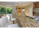 Eat-in kitchen offering granite countertops, stainless steel sink, and backyard patio access at 11102 Avery Oaks Dr, Tampa, FL 33625