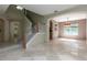 Open-concept living space with tile flooring, staircase, and natural light at 11102 Avery Oaks Dr, Tampa, FL 33625