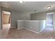 Carpeted loft area featuring neutral walls and trim with doorways leading to other rooms at 11102 Avery Oaks Dr, Tampa, FL 33625