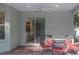 Covered patio featuring ceiling fan, comfortable seating, and view of the kitchen through sliding glass doors at 11102 Avery Oaks Dr, Tampa, FL 33625