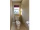 Powder room features marble floors and a window allowing for natural light at 11102 Avery Oaks Dr, Tampa, FL 33625