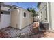 Backyard shed with white trim, surrounded by decorative stones, alongside the main house at 11102 Avery Oaks Dr, Tampa, FL 33625