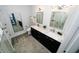 Modern bathroom showcasing double sinks, sleek mirrors, lighting and an entrance to a bedroom at 1120 E Kennedy Blvd # 1208, Tampa, FL 33602