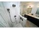 Modern bathroom with a tiled shower, glass enclosure, and vanity with double sinks at 1120 E Kennedy Blvd # 1208, Tampa, FL 33602