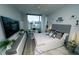Bright bedroom with large window overlooking the city, light gray walls, and light colored wood flooring at 1120 E Kennedy Blvd # 1208, Tampa, FL 33602