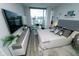 Bright bedroom with city views, a large TV, hardwood flooring, and comfortable modern furnishings at 1120 E Kennedy Blvd # 1208, Tampa, FL 33602