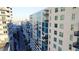 Exterior view of condo building with many balconies, neutral paint, and a clear blue sky at 1120 E Kennedy Blvd # 1208, Tampa, FL 33602