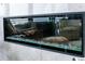 Contemporary fireplace displaying decorative crystal stones within a modern design and with a peek of the living room at 1120 E Kennedy Blvd # 1208, Tampa, FL 33602