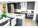 Modern kitchen features stainless steel appliances, stone countertops, stylish light fixtures and dark cabinets at 1120 E Kennedy Blvd # 1208, Tampa, FL 33602