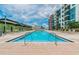 Inviting swimming pool with lounge chairs surrounded by condo complex on a sunny day at 1120 E Kennedy Blvd # 1208, Tampa, FL 33602