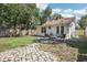 View of the backyard and the back of the house featuring green grass, stone walkway and brick patio at 1125 19Th N Ave, St Petersburg, FL 33704