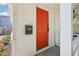 Close-up of a vibrant orange front door with a black mailbox on a stucco-covered porch at 1125 19Th N Ave, St Petersburg, FL 33704