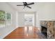 Bright living room with hardwood floors, ceiling fan and a stone fireplace for cozy evenings at 1125 19Th N Ave, St Petersburg, FL 33704