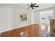 Bright living room with hardwood floors, ceiling fan, and view into an adjacent room at 1125 19Th N Ave, St Petersburg, FL 33704